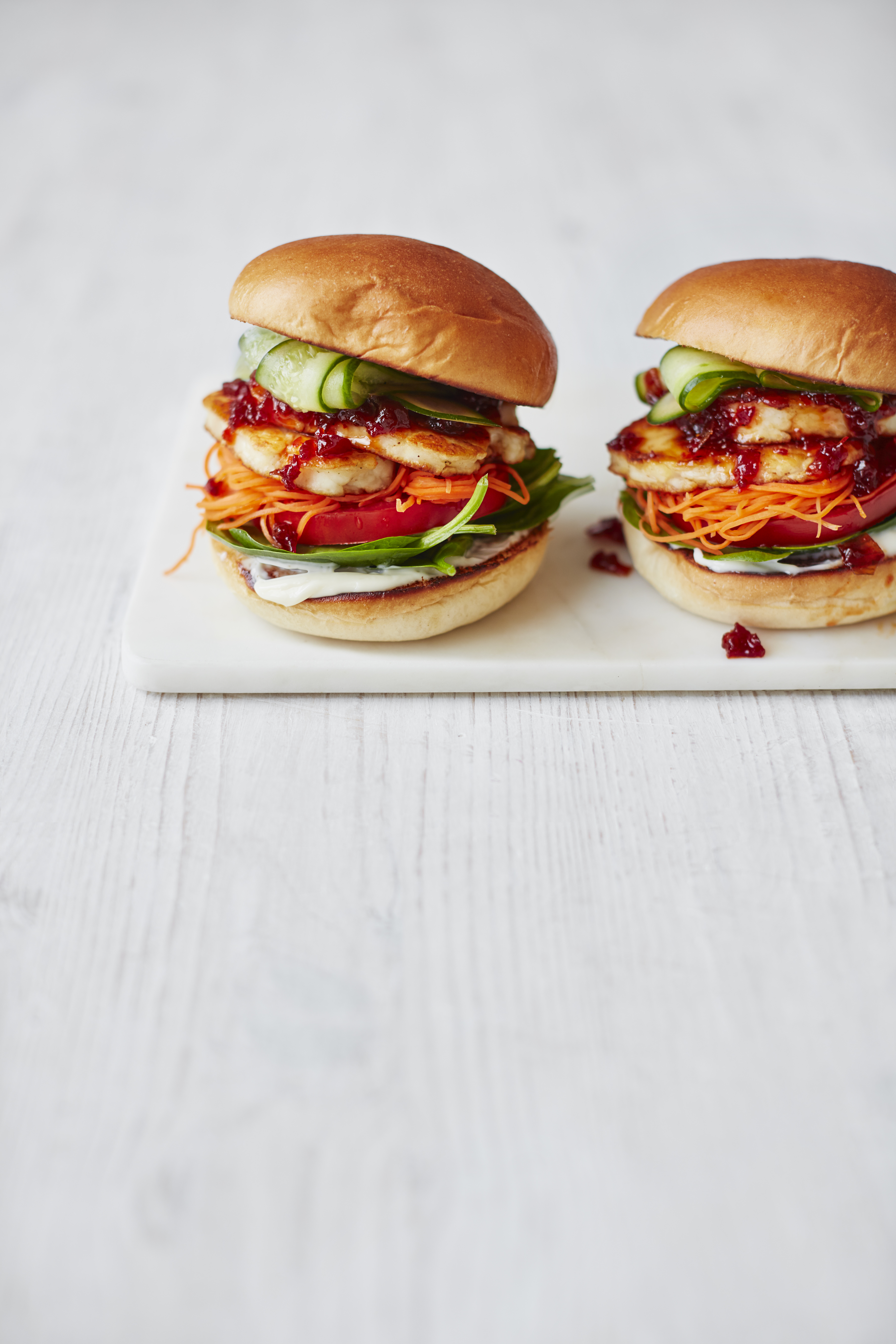 Halloumi burgers with chilli jam, spinach, carrot and cucumber