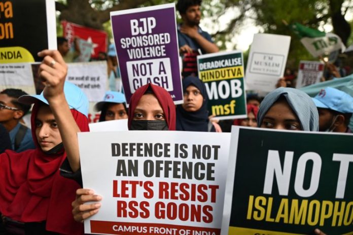 Protesters hold placards during a demonstration against anti-Muslim violence and hate crimes in New Delhi [File: Sajjad Hussain/AFP]