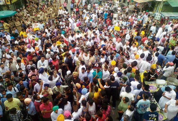 Hundreds of people take part in a march demanding justice for Moosewala in Mansa on Monday.