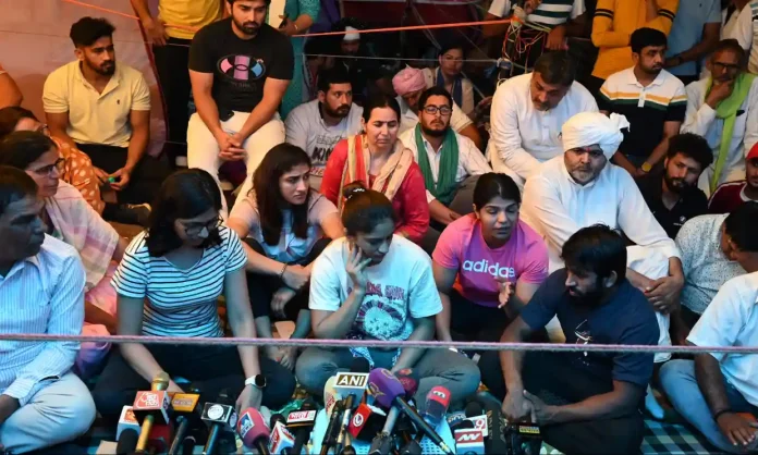 Demonstrators including Vinesh Phogat and Sakshi Malik talk to the media at the protest in New Delhi last week.