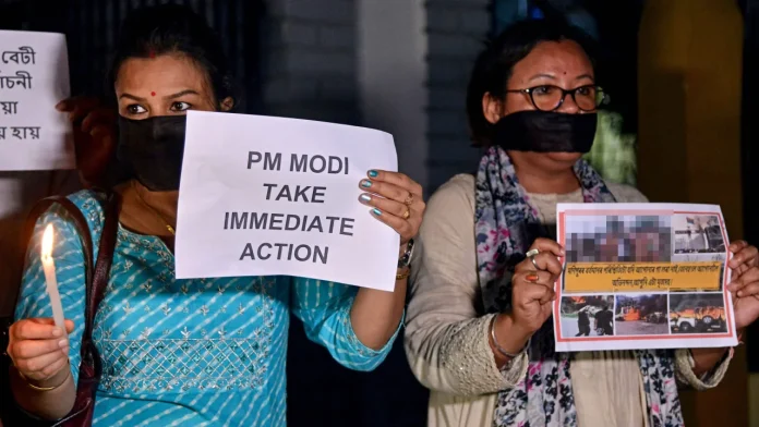 Protesters hold placards during a demonstration over sexual violence against women in Manipur, in Guwahati on Thursday. CNN has blurred a portion of this photograph that showed graphic imagery. Protesters hold placards during a demonstration over sexual violence against women in Manipur, in Guwahati on Thursday. CNN has blurred a portion of this photograph that showed graphic imagery.